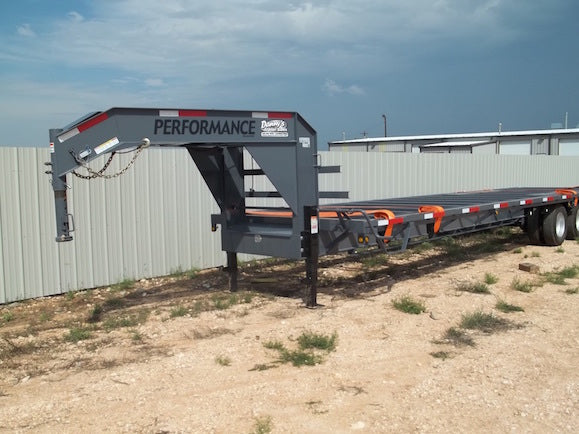 Gooseneck trailer with 'Performance' branding on a dirt lot.