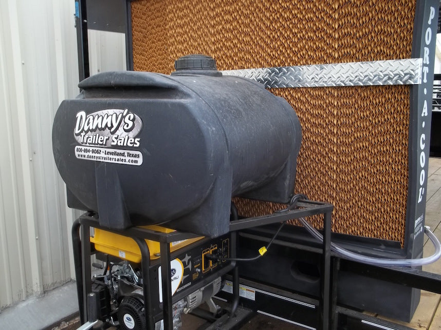 Black fuel tank on a stand with 'Danny's Trailer Sales' branding, attached to a trailer.
