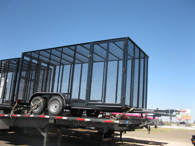 Black metal trailer with cage on a clear day